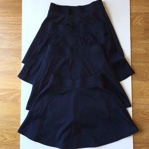 Four navy girls uniform skorts